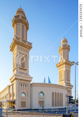 Manama, Bahrain - Jan 08 2024, Close up view of Ras Rumman Mosque, with the World trade center if Bahrain behind it, at daytime, Manama, Bahrain Manama, Bahrain - Jan 08 2024, Close up view of Ras Rumman Mosque, with the World trade center if Bahrain behind it, at daytime, Manama, Bahrain 139183459