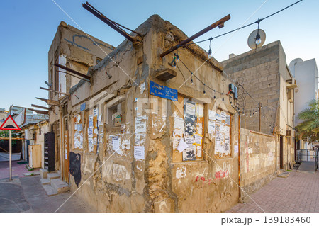 Manama, Bahrain - Jan 08 2024, View of the corner of an old dilapidated one-story house with a license plate, in the evening, Manama, Bahrain  139183460
