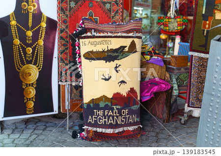 Manama, Bahrain - Jan 08 2024, A view of a small carpet with pattern referring to tragedy of the withdrawal of American troops from Afghanistan in 08, 15, 2021, the Fall of Kabul, Manama, Bahrain  139183545