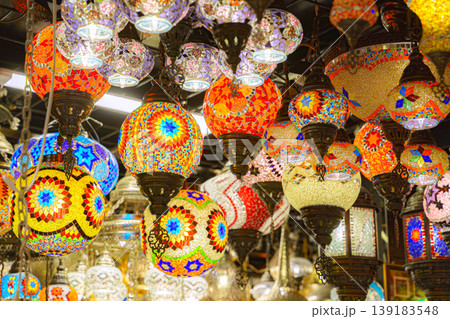 Manama, Bahrain - Jan 08 2024, A view from below of a variety of many colorful vintage Arabic and Persian lamps and chandeliers, Fanoos, Manama, Bahrain 139183548