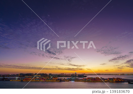 Doha, Qatar - Jan 07 2024, a panoramic view of the colorful evening sky with light clouds, below there is a view of Doha and the port, at sunset, Doha, Qatar Doha, Qatar - Jan 07 2024, a panoramic view of the colorful evening sky with light clouds, below there is a view of Doha and the port, at sunset, Doha, Qatar 139183670