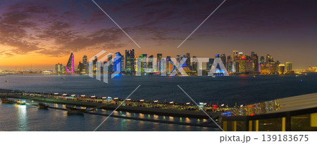 Doha, Qatar - Jan 07 2024, an aerial view of the Doha coastline filled with dark skyscrapers, at sunset, evening, Doha, Qatar Doha, Qatar - Jan 07 2024, an aerial view of the Doha coastline filled with dark skyscrapers, at sunset, evening, Doha, Qatar 139183675