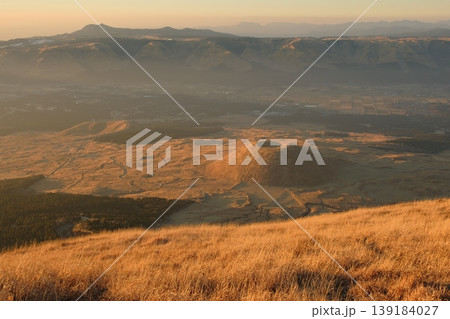 阿蘇・米塚とカルデラを囲む北外輪山の夕景・黄金色の草原と巨大な地形の全景 139184027