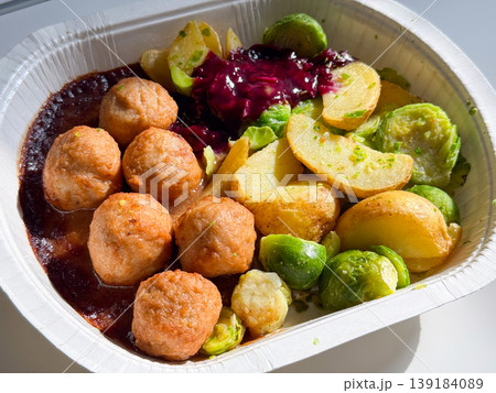 Close-up Swedish meatball meal with potato and Brussels sprout served in a takeaway container. Comfort food, fast lunch, convenience, and casual dining experience 139184089