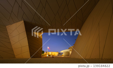 Doha, Qatar - Jan 06 2024, a panoramic view of wide passage with low ceiling, in National Museum of Qatar, in shape of desert rose, at nighttime, Doha, Qatar Doha, Qatar - Jan 06 2024, a panoramic view of wide passage with low ceiling, in National Museum of Qatar, in shape of desert rose, at nighttime, Doha, Qatar 139184822