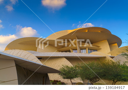 Doha, Qatar - Jan 06 2024, a panoramic view of National Museum of Qatar facade, exterior, shaped like a desert rose, at evening with blue sky, Doha, Qatar Doha, Qatar - Jan 06 2024, a panoramic view of National Museum of Qatar facade, exterior, shaped like a desert rose, at evening with blue sky, Doha, Qatar 139184917