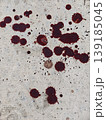 Red Stains Splattered Across a Weathered Concrete Surface Outdoor Natural Light Impromptu Artistic Composition for Commercial Applications 139185045