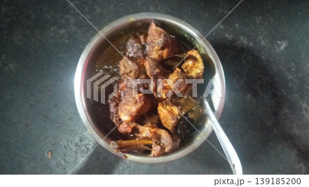 Rich and Spicy Chicken Masala Curry in Stainless Steel Serving Bowl 139185200