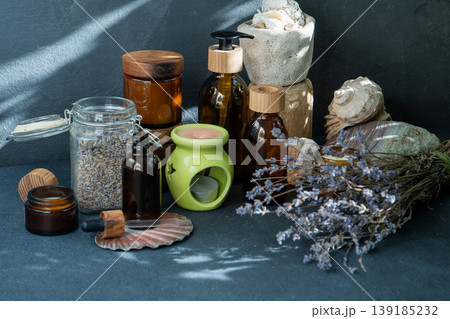 Scented candles and jars with essential oil. Dried lavender. Aromatherapy Scented candles and jars with essential oil. Dried lavender. Aromatherapy 139185232