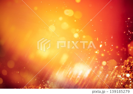 Vibrant abstract background with warm orange and red hues, featuring soft bokeh lights and shimmering textures, creating a festive and energetic atmosphere for design projects 139185279