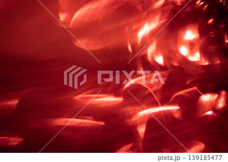 Abstract red light patterns with blurred shapes and reflections creating a vibrant and dynamic visual effect suitable for backgrounds or artistic designs Abstract red light patterns with blurred shapes and reflections creating a vibrant and dynamic visual effect suitable for backgrounds or artistic designs 139185477