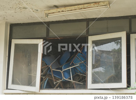 broken blue chair and table arranging block window in old school building on Thailand 139186378