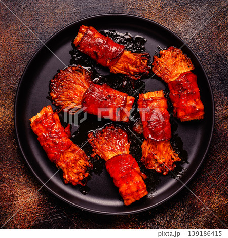 Bacon roll with enoki mushroom grilled with sauce. Bacon roll with enoki mushroom grilled with sauce. 139186415