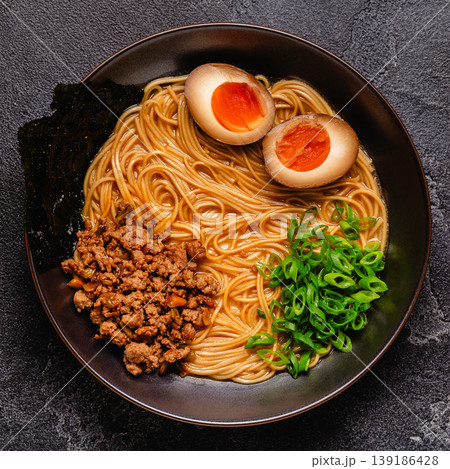 A bowl of ramen with noodles, meat and green onions. A bowl of ramen with noodles, meat and green onions. 139186428