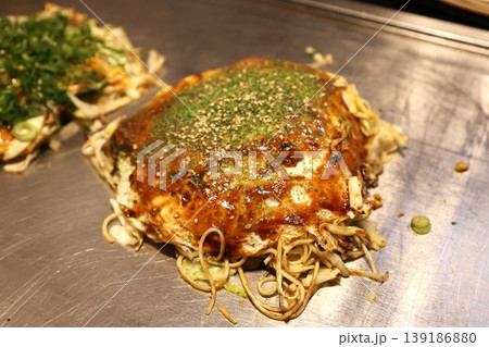 鉄板の上で焼かれる広島名物のお好み焼き 鉄板の上で焼かれる広島名物のお好み焼き 139186880
