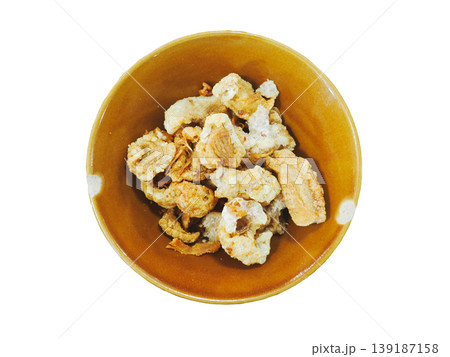 Top view of crispy deep fried pork rinds in ceramic bowl isolated on white background Top view of crispy deep fried pork rinds in ceramic bowl isolated on white background 139187158