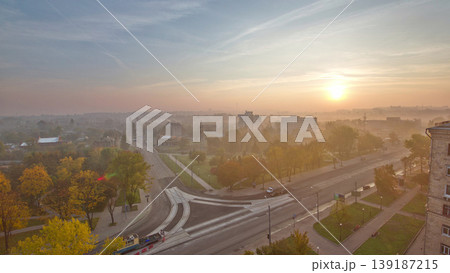 Sunrise over road intersection with reconstructed tram tracks aerial panoramic timelapse. 139187215