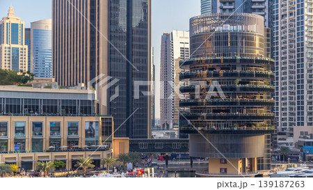 Aerial view of Dubai Marina with shopping mall, restaurants, towers and yachts timelapse, United Arab Emirates. 139187263