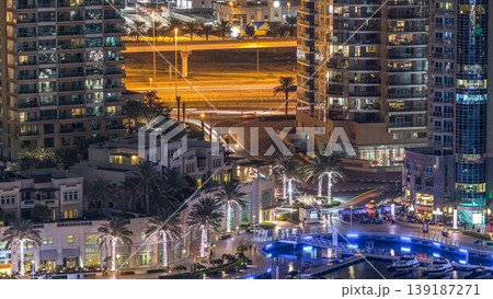 Luxury Dubai Marina canal with passing boats and promenade night timelapse, Dubai, United Arab Emirates 139187271