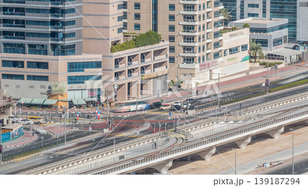 Aerial view of a road intersection in a big city timelapse. Aerial view of a road intersection in a big city timelapse. 139187294