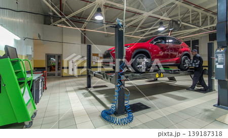 Car on stand with sensors on wheels for wheels alignment camber check in workshop of Service station timelapse. Car on stand with sensors on wheels for wheels alignment camber check in workshop of Service station timelapse. 139187318