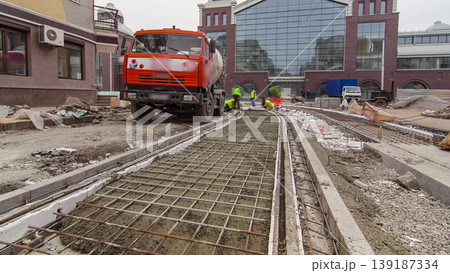 Pouring ready-mixed concrete after placing steel reinforcement to make the road by concrete mixer timelapse hyperlapse. Pouring ready-mixed concrete after placing steel reinforcement to make the road by concrete mixer timelapse hyperlapse. 139187334