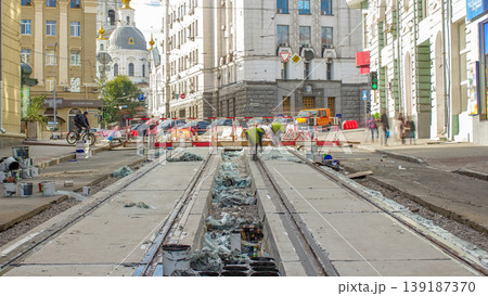Workers do cleaning of the railway tram line after construction works. 139187370