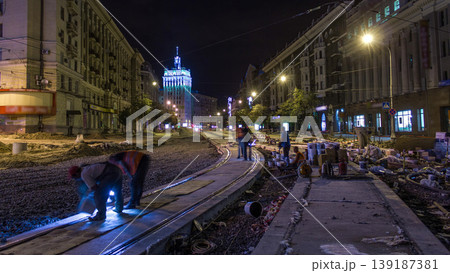 Tram rails at the stage of their installation and integration into concrete plates on the road night timelapse Tram rails at the stage of their installation and integration into concrete plates on the road night timelapse 139187381