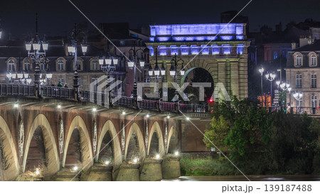 Pont de Pierre stone bridge with Porte de Bourgogne night timelapse in Bordeaux, France. 139187488