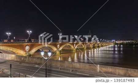 Pont de Pierre stone bridge with Porte de Bourgogne night timelapse in Bordeaux, France. Pont de Pierre stone bridge with Porte de Bourgogne night timelapse in Bordeaux, France. 139187493