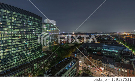 Aerial night timelapse of Brussels urban landscape blending office skyscrapers with residential areas. Aerial night timelapse of Brussels urban landscape blending office skyscrapers with residential areas. 139187531