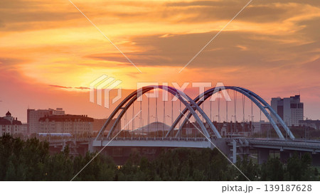 Sunset timelapse above the Bridge with the transport and clouds on the background. Central Asia, Kazakhstan, Astana Sunset timelapse above the Bridge with the transport and clouds on the background. Central Asia, Kazakhstan, Astana 139187628