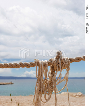 Nautical rope closeup with a blurred seaside background with copy space 139187866