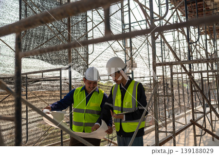 Construction project planning construction site action image urban environment close-up view collaboration and safety Construction project planning construction site action image urban environment close-up view collaboration and safety 139188029