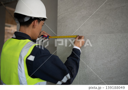 Measuring construction progress building site professional activity urban environment close-up view precision and planning Measuring construction progress building site professional activity urban environment close-up view precision and planning 139188049