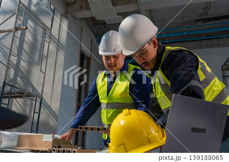 Construction workers collaborate on project industrial site photography indoor environment close-up view teamwork in action 139188065