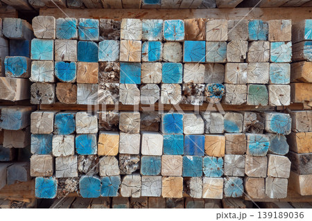 Stacked wooden beam ends with weathered blue paint, rustic timber wall texture Stacked wooden beam ends with weathered blue paint, rustic timber wall texture 139189036