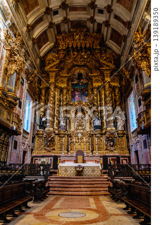 Interior of Porto cathedral nave with golden altar and wooden benches 139189350