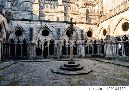Porto cathedral cloister with gothic arches and central stone cross 139189355