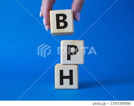 BPH - Benign Prostatic Hyperplasia symbol. Wooden cubes with word BPH. Businessman hand. Beautiful blue background. Medical and BPH concept. Copy space. BPH - Benign Prostatic Hyperplasia symbol. Wooden cubes with word BPH. Businessman hand. Beautiful blue background. Medical and BPH concept. Copy space. 139189996