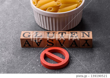 Italian uncooked dry penne regatta pasta with a gluten prohibition sign. The gluten prohibition sign Italian uncooked dry penne regatta pasta with a gluten prohibition sign. The gluten prohibition sign 139190521