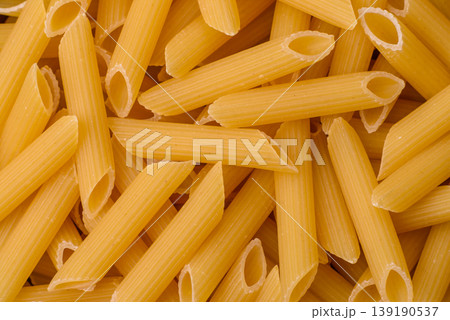 Italian uncooked dry penne regate pasta ready for cooking. Dry penne pasta 139190537