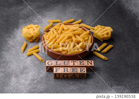 Italian uncooked, dry, gluten free penne pasta, ready for cooking. Dry, gluten free penne pasta Italian uncooked, dry, gluten free penne pasta, ready for cooking. Dry, gluten free penne pasta 139190538