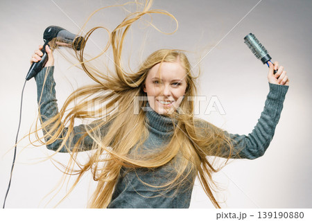 Girl holds hair accessories, styling hair Girl holds hair accessories, styling hair 139190880