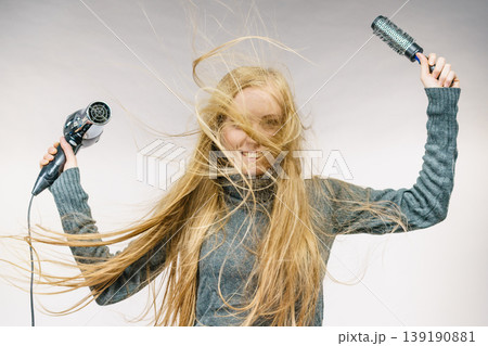 Girl holds hair accessories, styling hair 139190881