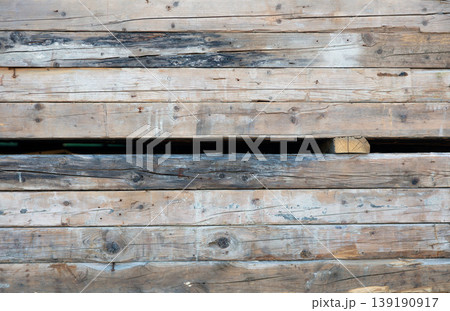 Stack of weathered rough wooden planks, rustic reclaimed timber wall texture 139190917