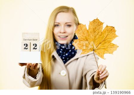 Woman holding calendar with first autumn day Woman holding calendar with first autumn day 139190966
