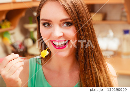 Woman eating cream cake with fruits. Gluttony. 139190999