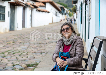 Happy senior woman concept. Senior travel concept. Senior woman at the beautiful colonial town of Villa de Leyva in Colombia 139191442