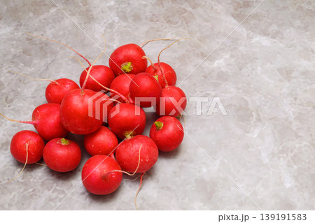 pile of red radishes on gray marble with free space pile of red radishes on gray marble with free space 139191583